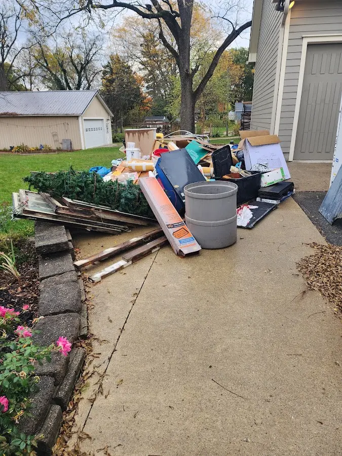 Dumpster being loaded with debris for Commercial Dumpster Rental in Garnett